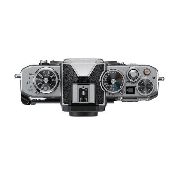 Top-down retro control dials on silver Nikon Zfc mirrorless camera body by ClubCamera.com
