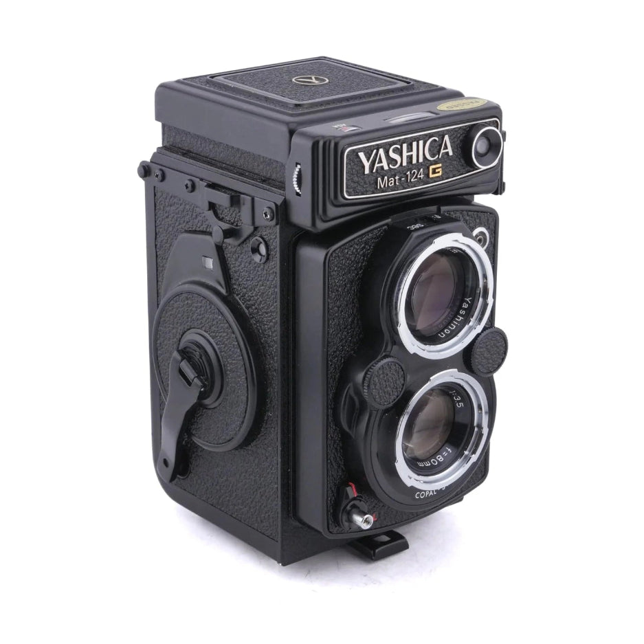 Black Yashica Mat-124G twin-lens reflex camera front view with red shutter release