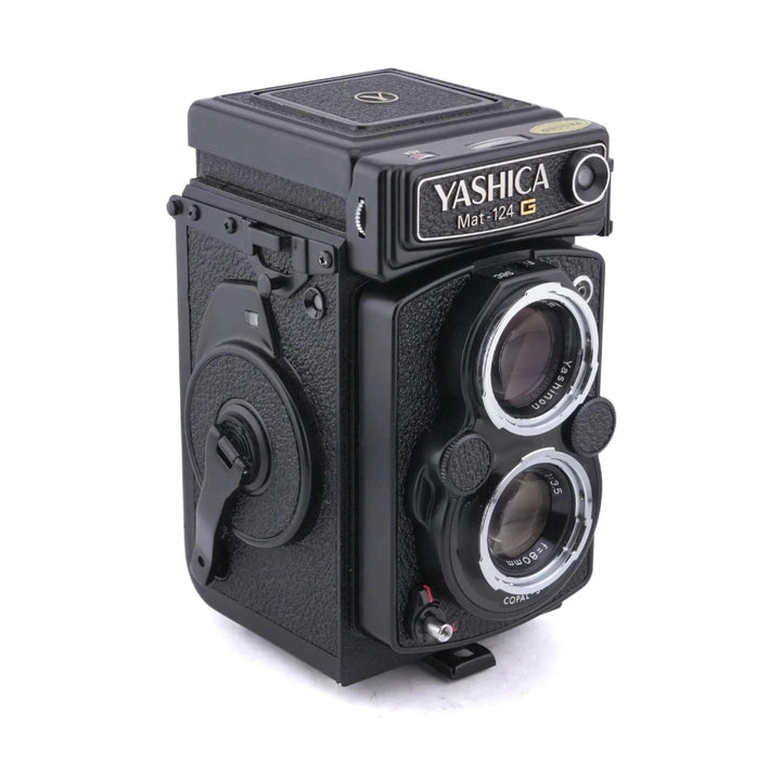 Black Yashica Mat-124G twin-lens reflex camera front view with red shutter release
