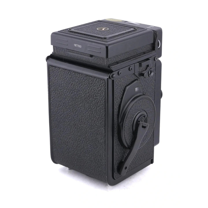 Rear view of black Yashica Mat-124G showing film rewind crank and serial number