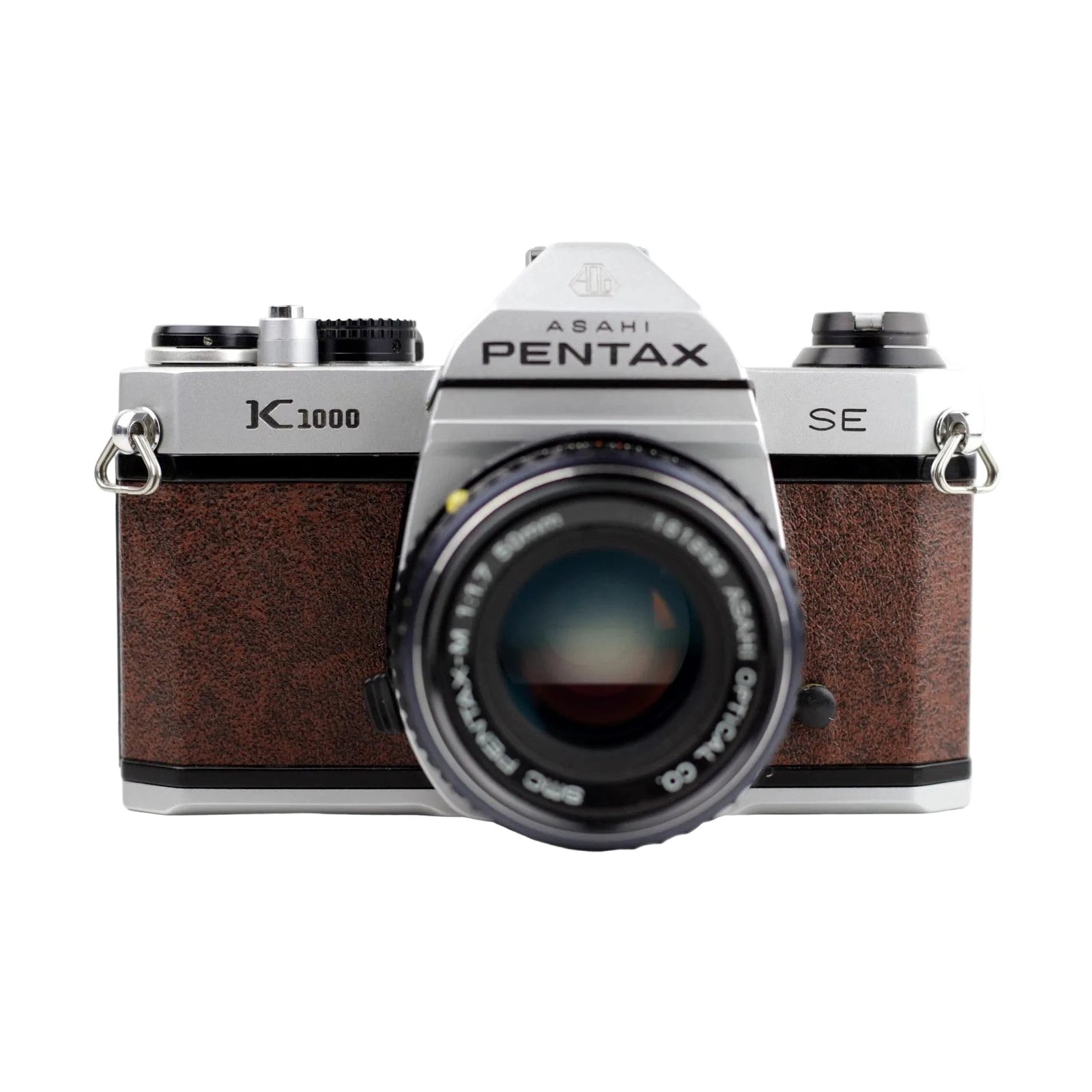 Front angled shot of brown leatherette Pentax K1000 SE SLR with PENTAX-M 50mm lens by ClubCamera.com