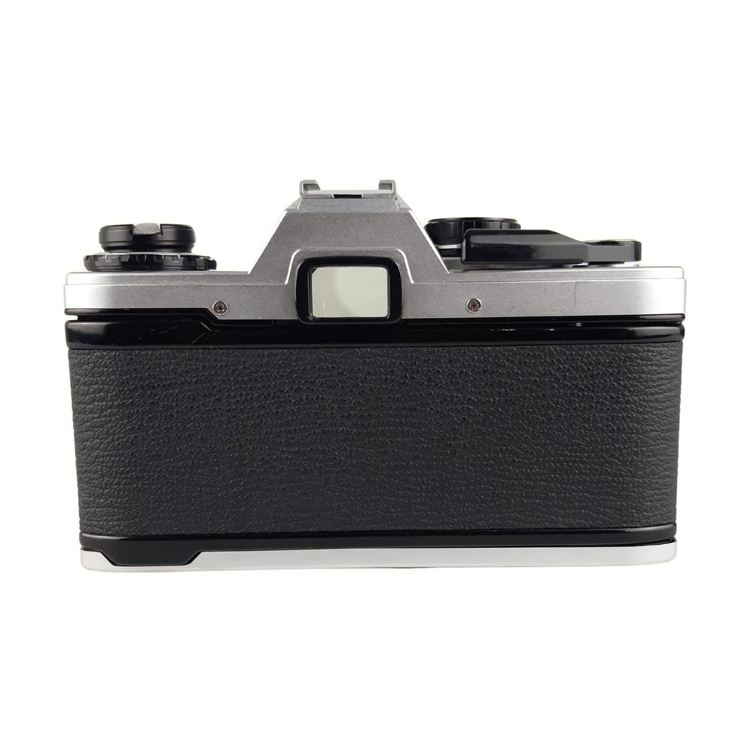ClubCamera silver brushed aluminum Olympus OM-10 SLR film camera top-down view with black leatherette grip