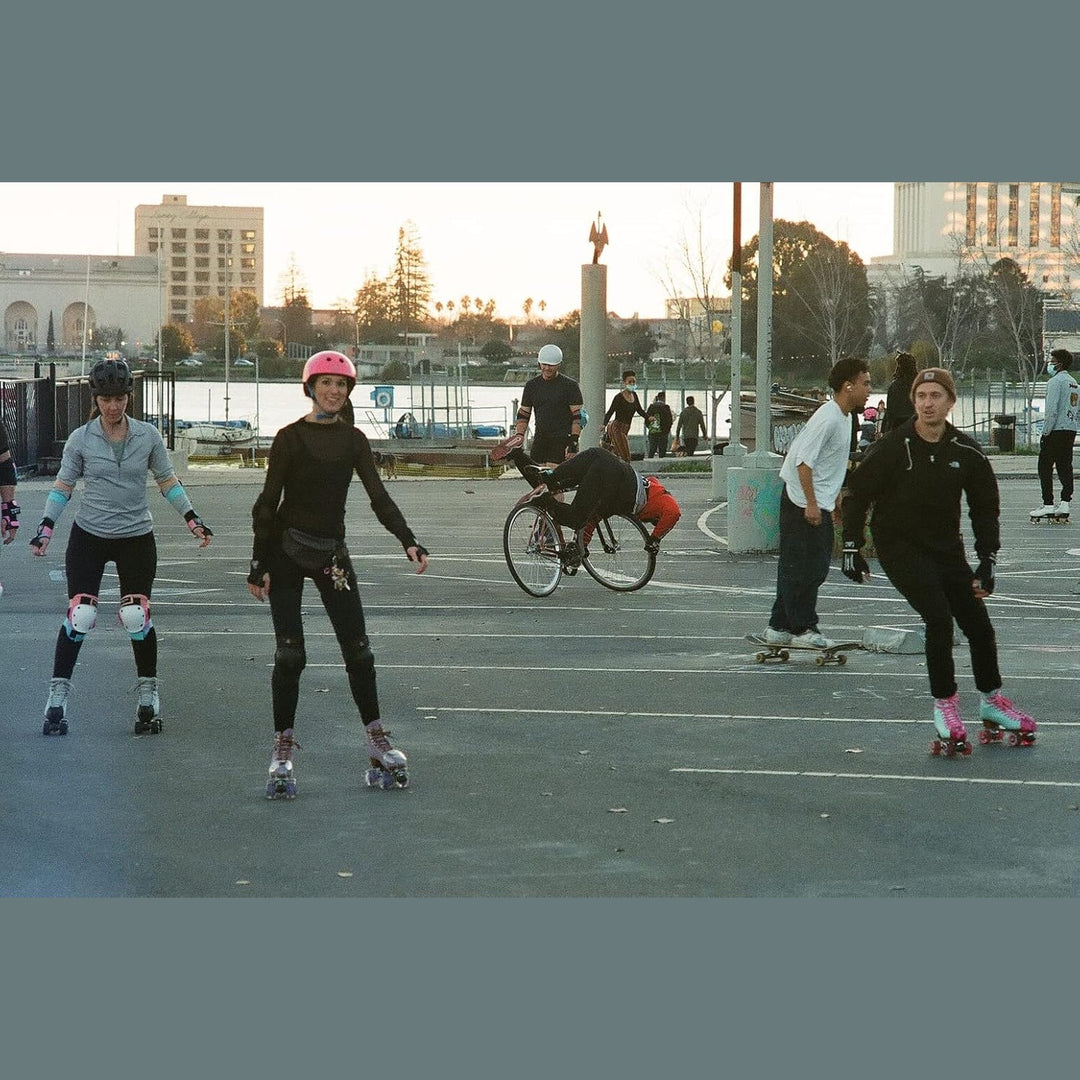 People roller skating in urban parking lot at sunset