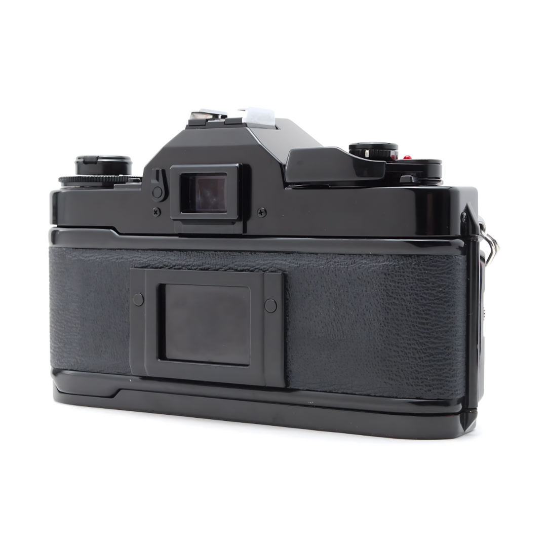 Rear-three-quarter view of black Canon A-1 SLR highlighting rubberized grip and viewfinder window at ClubCamera.com