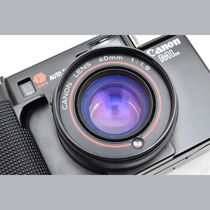 Canon AF35ML Super Sure Shot 35mm film camera close-up with red-orange lens ring and purple coating at ClubCamera.com