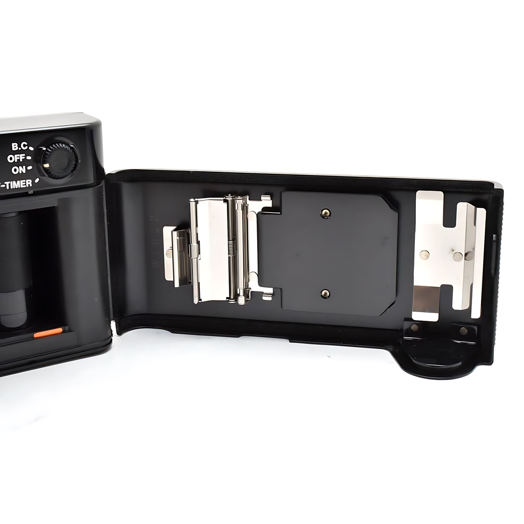 Detailed open film compartment of Canon AF35ML showing metal transport mechanism and pressure plates at ClubCamera.com