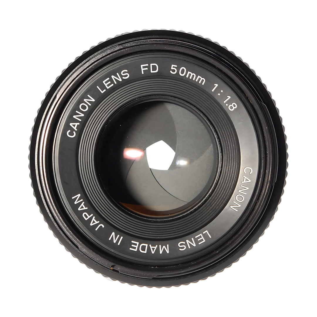 Close-up of black Canon FD 50mm f/1.8 lens with focus ring and glass element