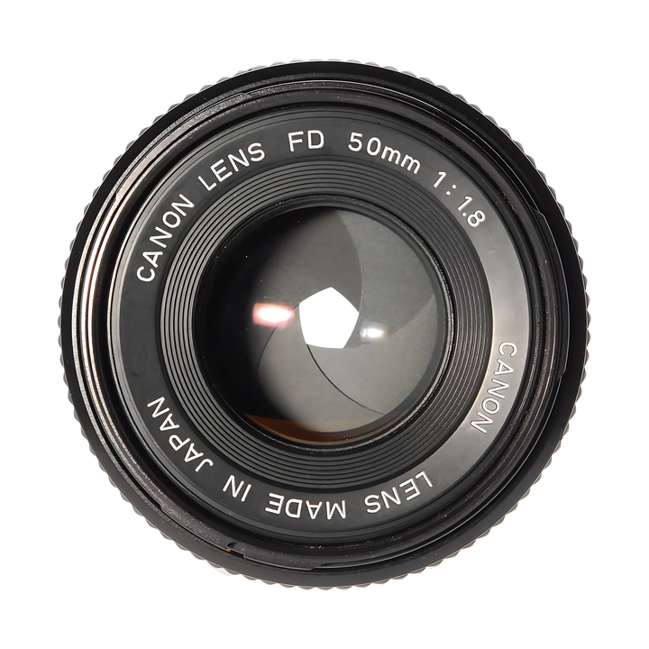 Close-up of black Canon FD 50mm f/1.8 lens with focus ring and glass element