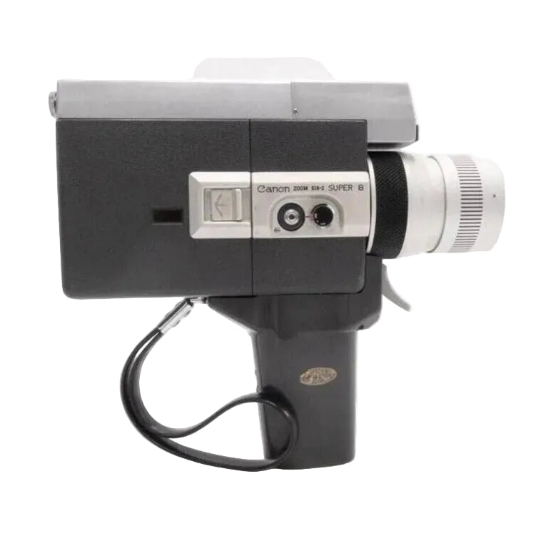 Side view of Canon Auto Zoom 518 Super 8 film camera with fixed handle from ClubCamera.com, matte black textured grip and silver control panel