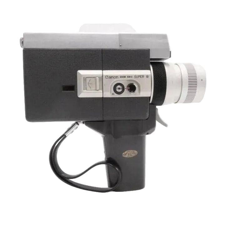 Side view of Canon Auto Zoom 518 Super 8 film camera with fixed handle from ClubCamera.com, matte black textured grip and silver control panel