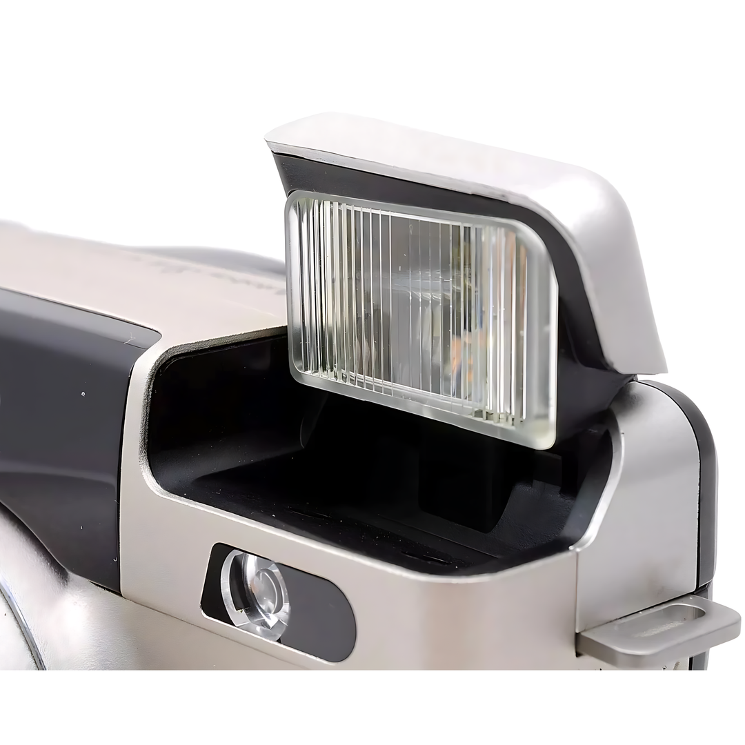 Close-up of open pop-up flash unit on silver Canon Prima Super 135 with translucent diffuser and internal reflector detail from ClubCamera.com