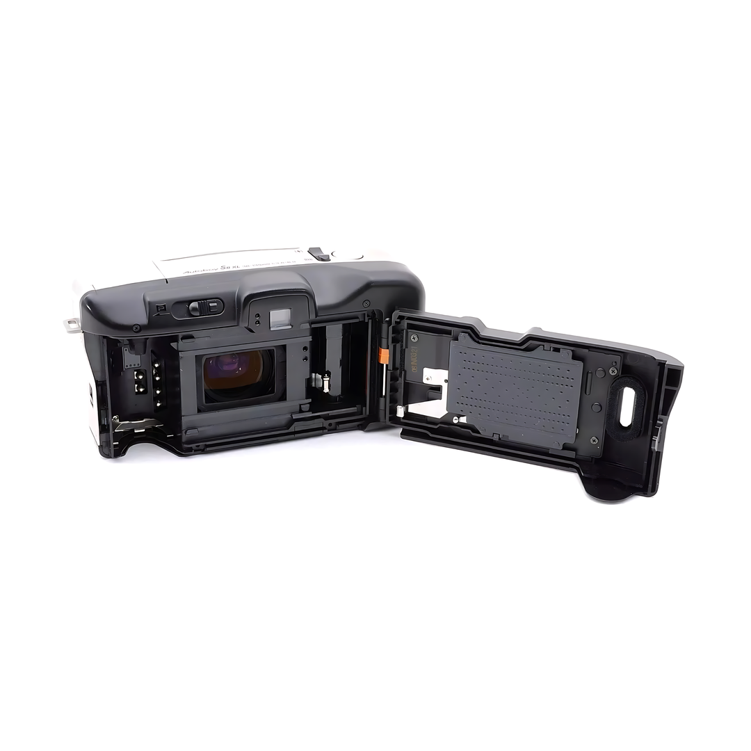 Rear view of black Canon Autoboy S II XL showing film door hinge, orange alignment tab, and printed specs on silver top plate from ClubCamera.com