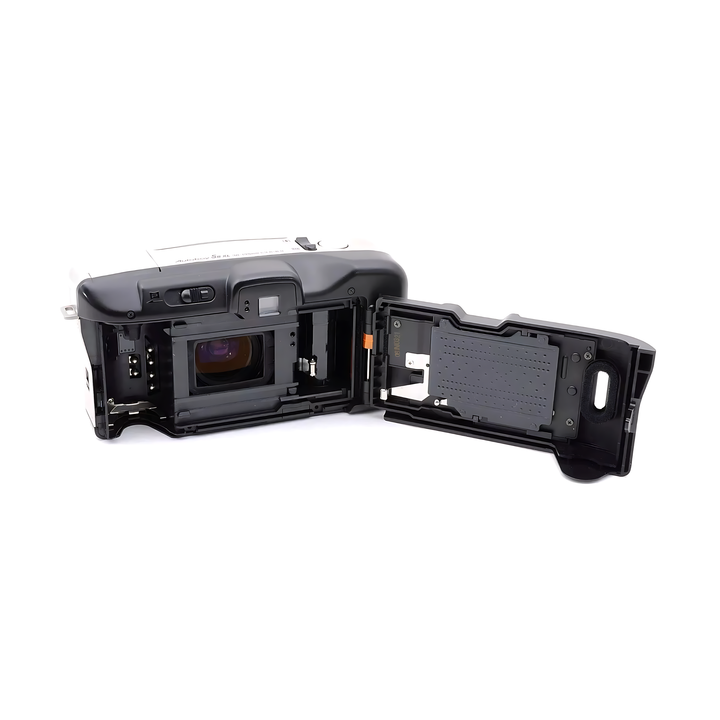 Rear view of black Canon Autoboy S II XL showing film door hinge, orange alignment tab, and printed specs on silver top plate from ClubCamera.com