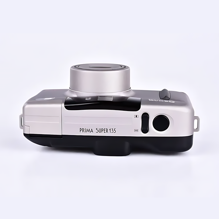 Rear view of silver Canon Prima Super 135 with folded-out rectangular flash unit and vertical ribbed diffuser structure from ClubCamera.com