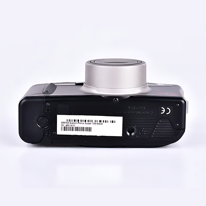 Back of black Canon Prima Super 135 with white barcode label, CE marking, and embossed Canon Japan text on plastic casing at ClubCamera.com
