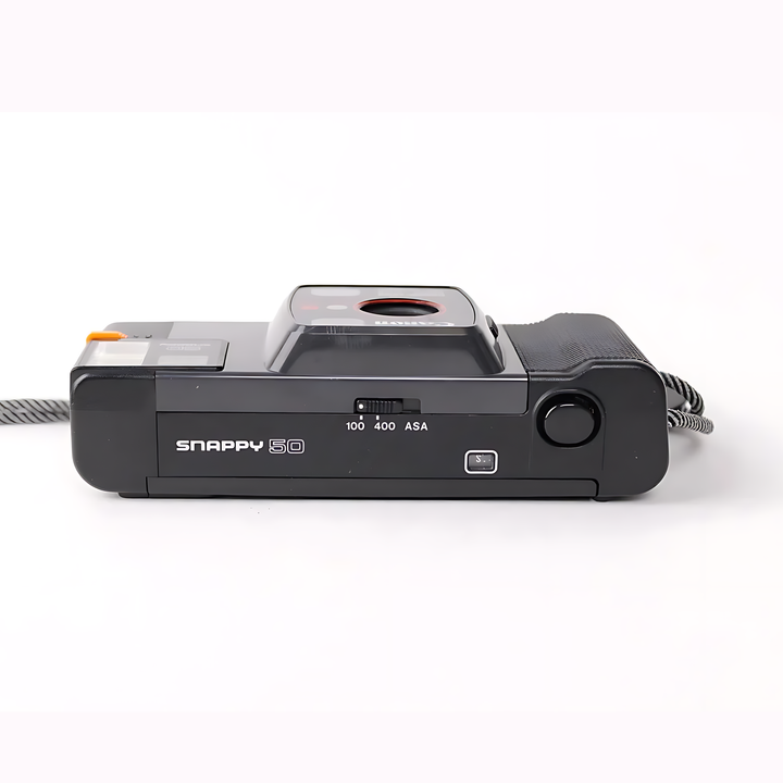 Bottom view of Canon Snappy 50 displaying sliding ASA selector and shutter release button at ClubCamera.com