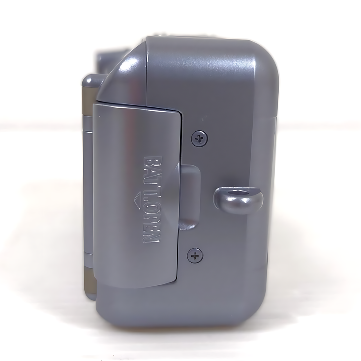 Side view Canon Sure Shot 130uII battery compartment door labeled BATT OPEN and metal latch at ClubCamera.com