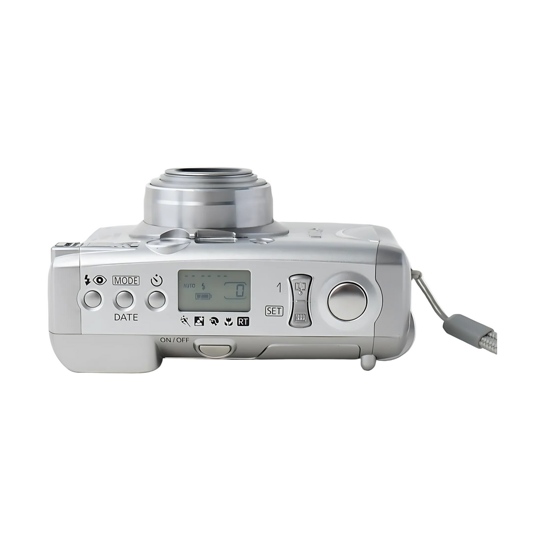 Top right angle of silver Canon Sure Shot 150u displaying LCD screen set to AUTO mode and control dials at ClubCamera.com