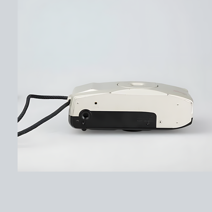 Side profile of compact cream and black Canon Sure Shot 60 Zoom showing tripod mount and slim body