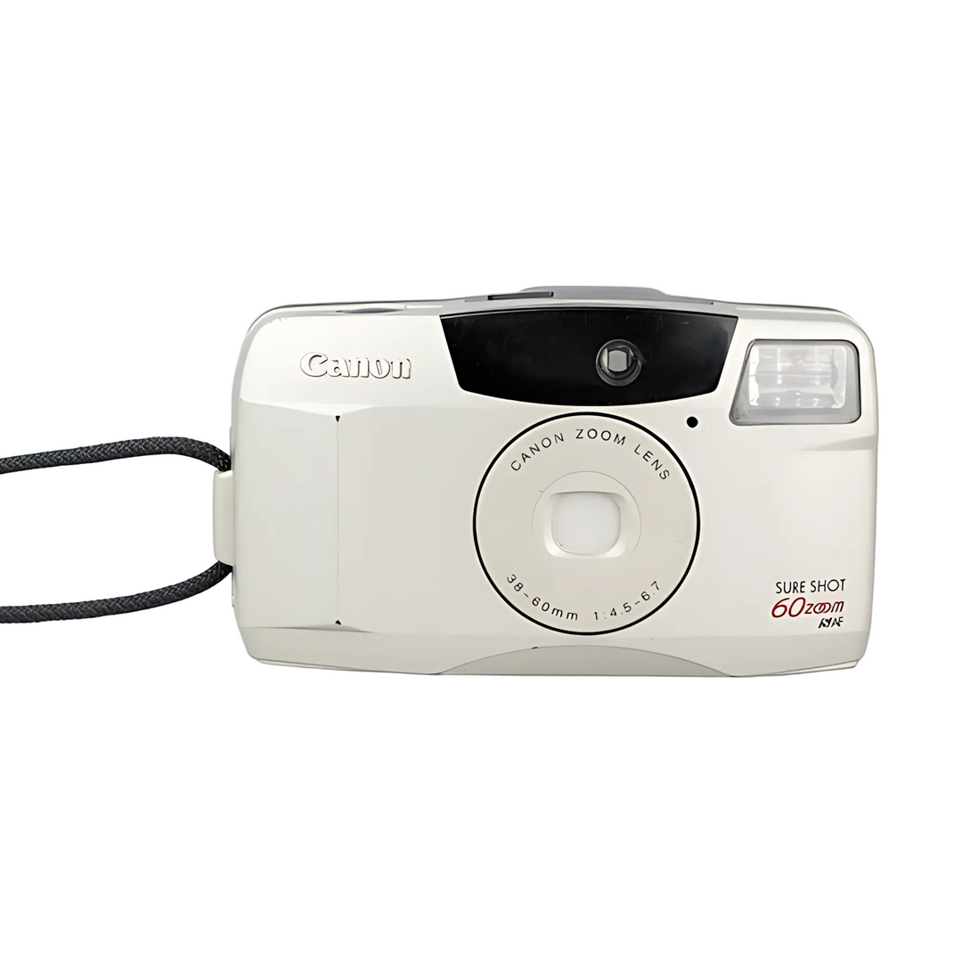 Cream Canon Sure Shot 60 Zoom point-and-shoot film camera with textured wrist strap and zoom lens