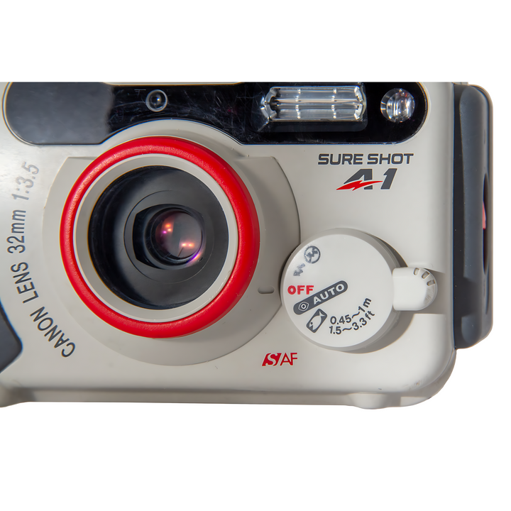 Close-up of Canon Sure Shot A-1 32mm lens with vivid red ring and white mode dial settings