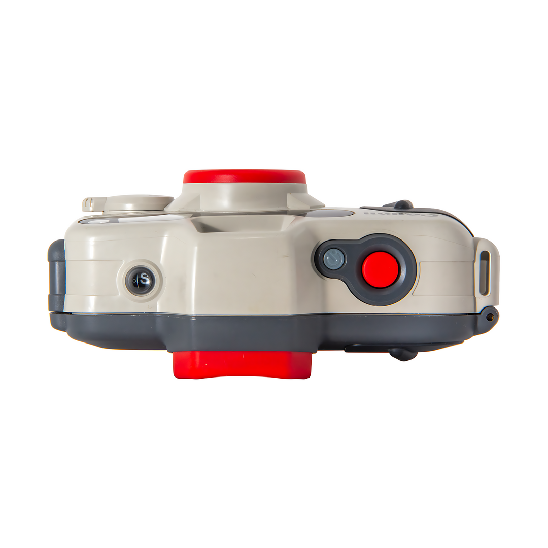Top profile of beige Canon Sure Shot A-1 with red shutter button and waterproof base plate detail
