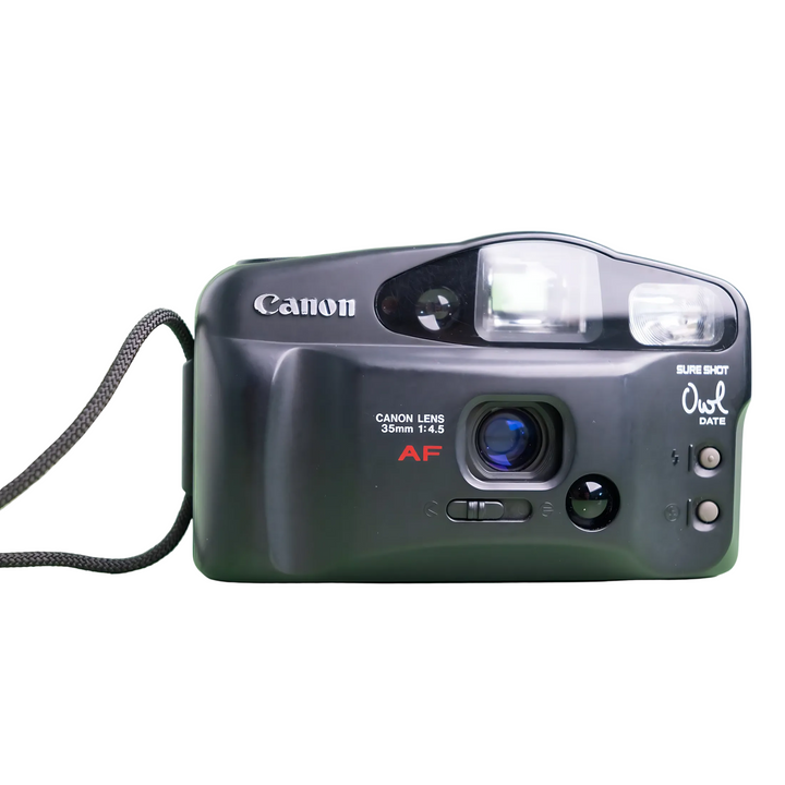 Close-up of Canon Sure Shot Owl lens with blue glass element and AF badge at ClubCamera.com