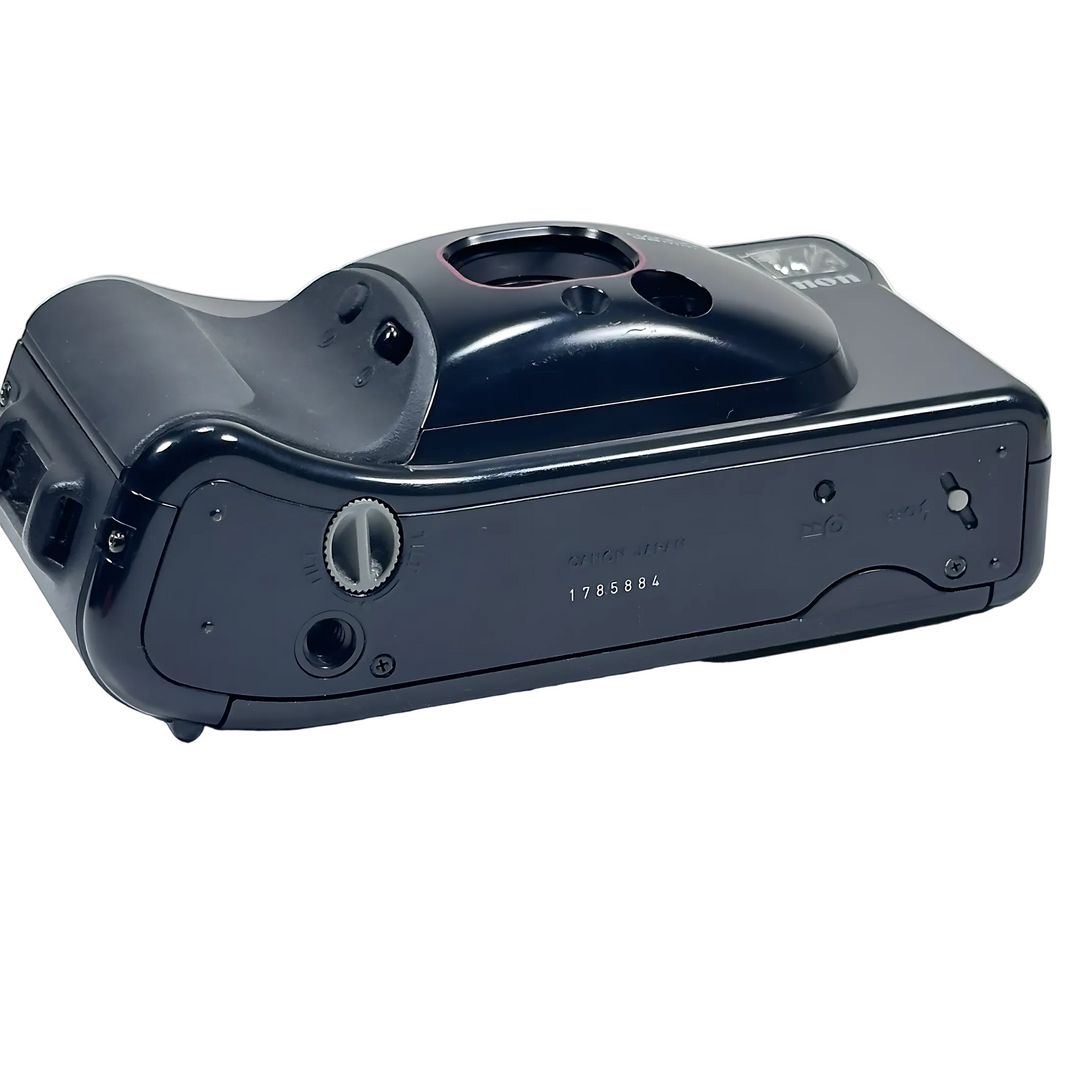 Bottom view of Canon Sure Shot Supreme showing matte plastic casing, battery compartment cover, and engraved serial number 1785884 at ClubCamera.com