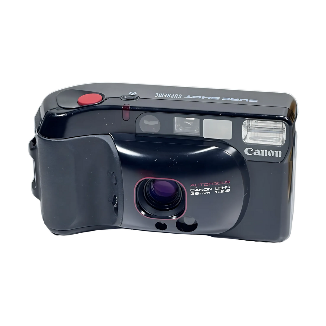 Front view of Canon Sure Shot Supreme 35mm point-and-shoot camera with red shutter button, purple lens, and autofocus label from ClubCamera.com
