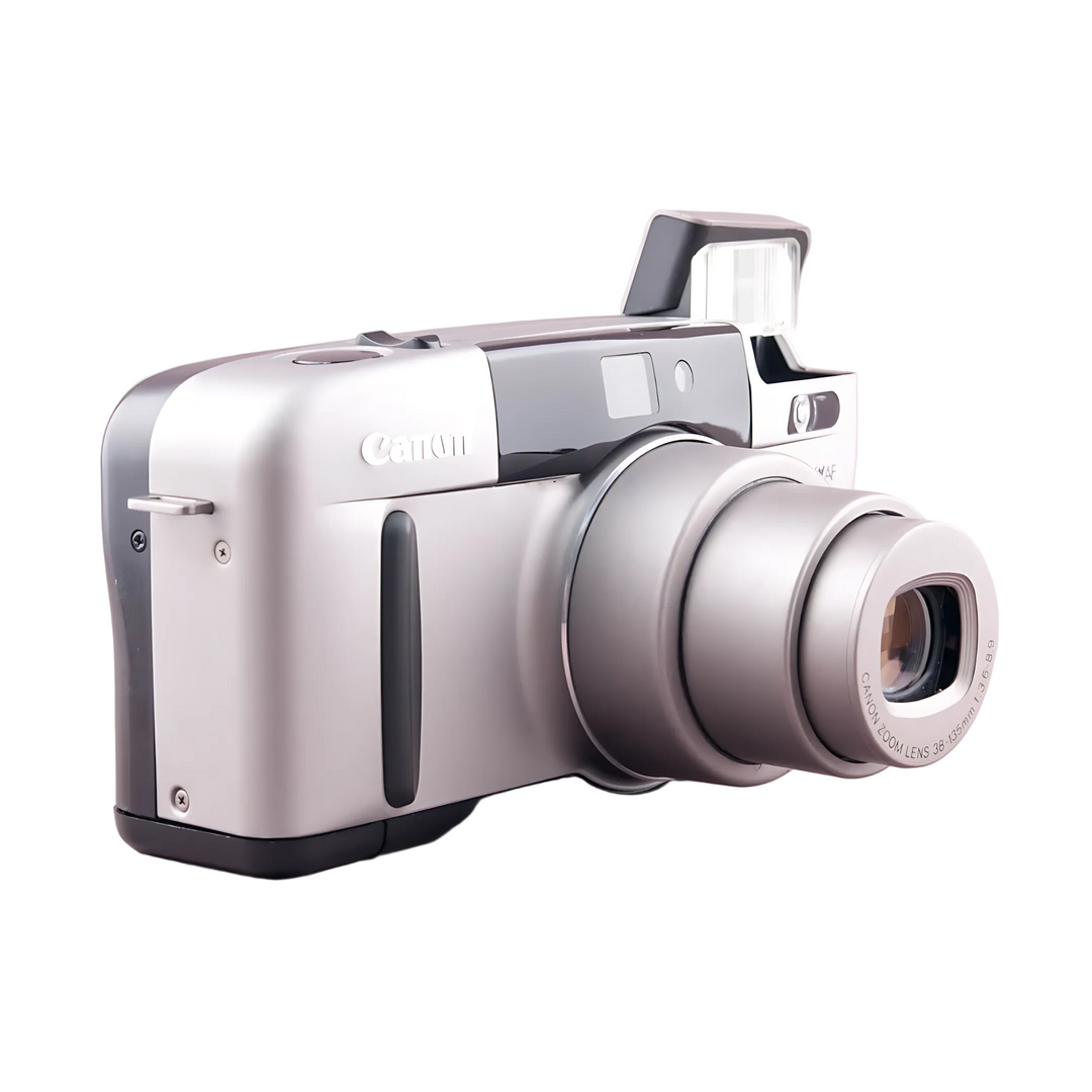 Angled side view of silver Canon Sure Shot Z135 Zoom showing ergonomic curves and zoom barrel