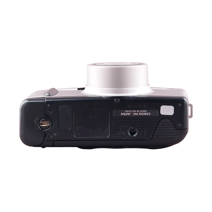 Bottom view of Canon Sure Shot Z135 Zoom showing Made in Malaysia label and battery contacts