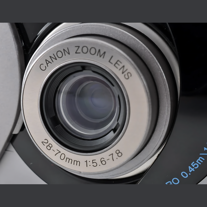 Close-up of Canon Z70W brushed silver lens barrel engraved with 28-70mm zoom specifications