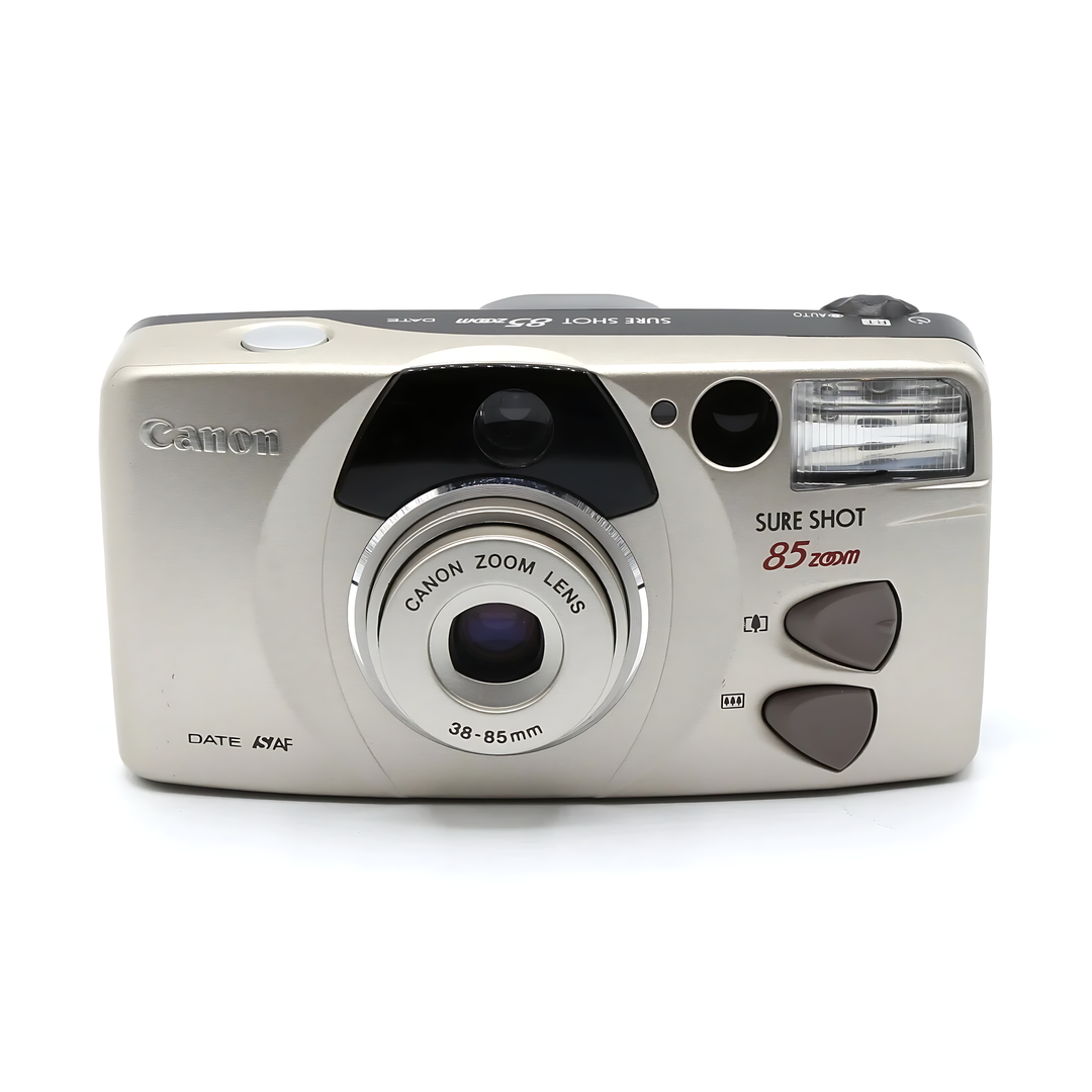 Direct front view of silver Canon Sure Shot 85 Zoom Date emphasizing lens inscription and buttons at ClubCamera.com