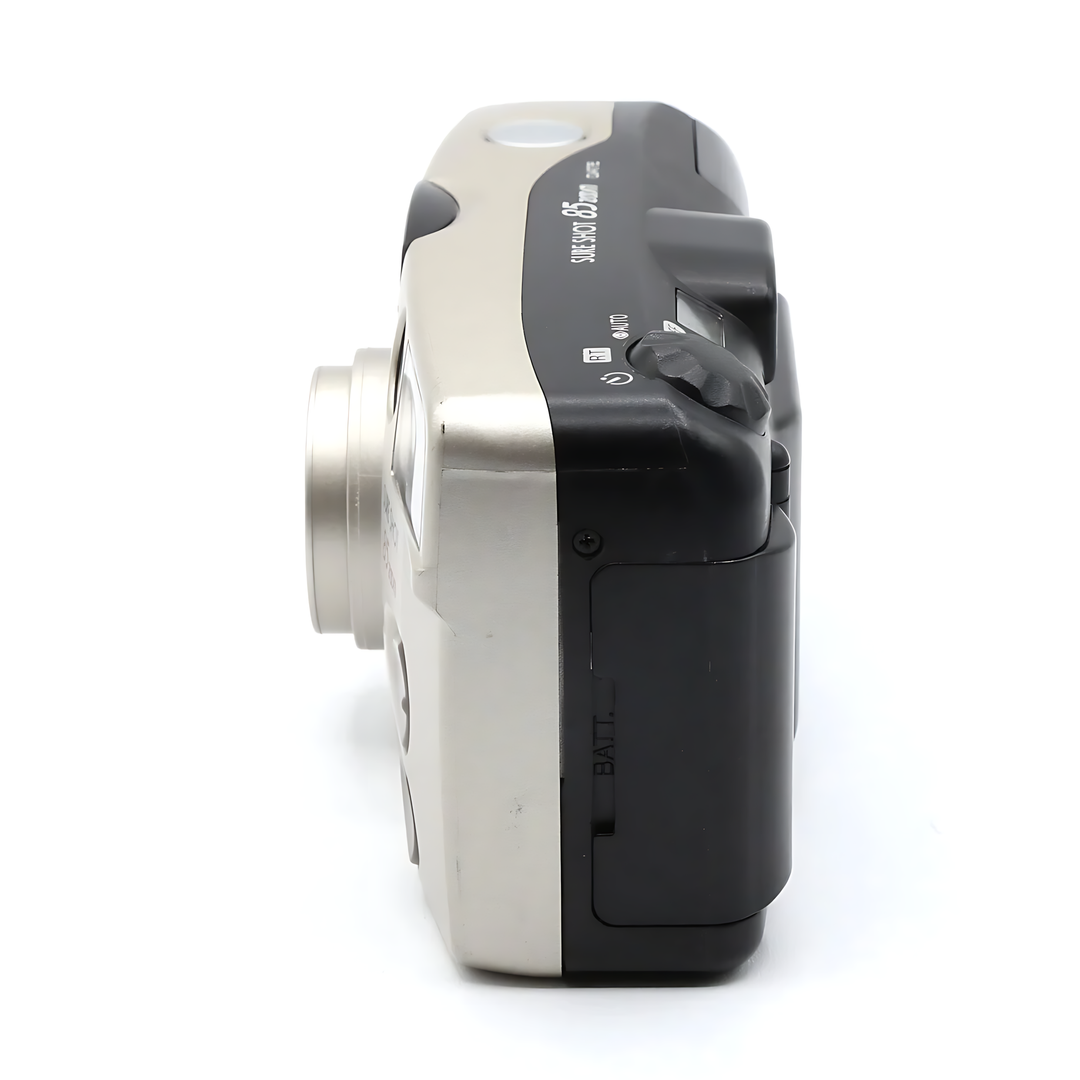 Canon Sure Shot 85 Zoom Date battery compartment and mode dial detail on silver film camera from ClubCamera.com