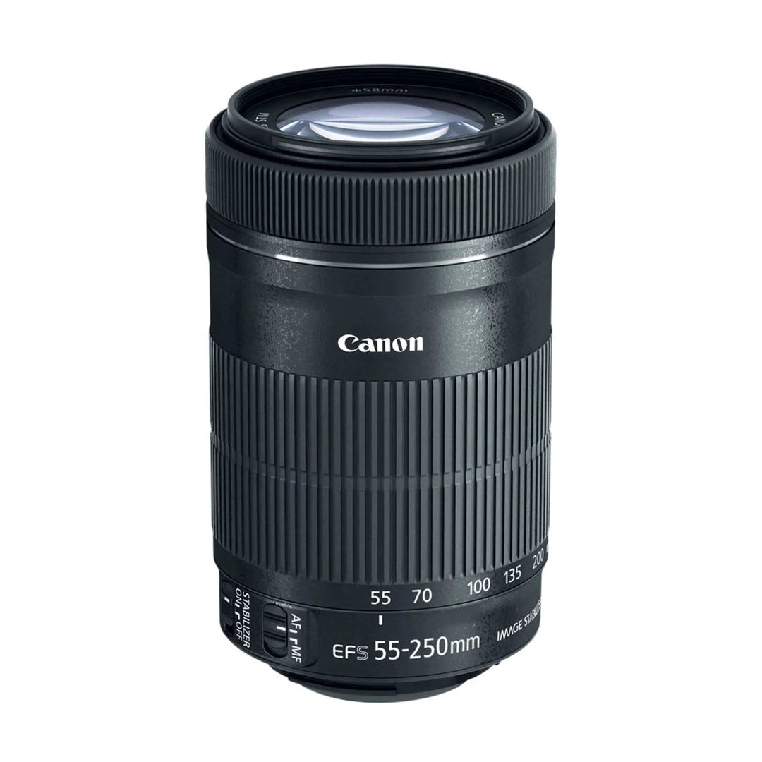 Top-down angled shot of black Canon EF-S 55-250mm lens showing blue anti-reflective glass element and compact cylindrical form at ClubCamera.com