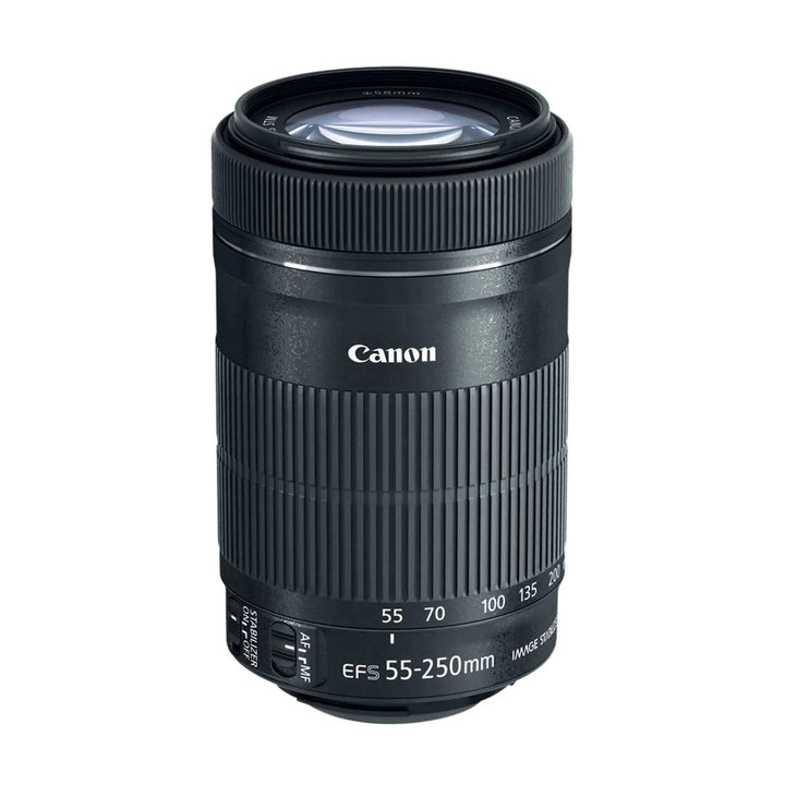 Top-down angled shot of black Canon EF-S 55-250mm lens showing blue anti-reflective glass element and compact cylindrical form at ClubCamera.com