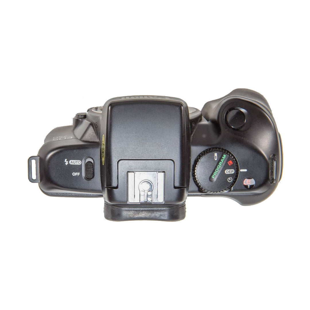 ClubCamera.com top-down view of black Canon EOS 750 SLR showing AUTO mode dial, silver hot shoe mount, and shutter release button