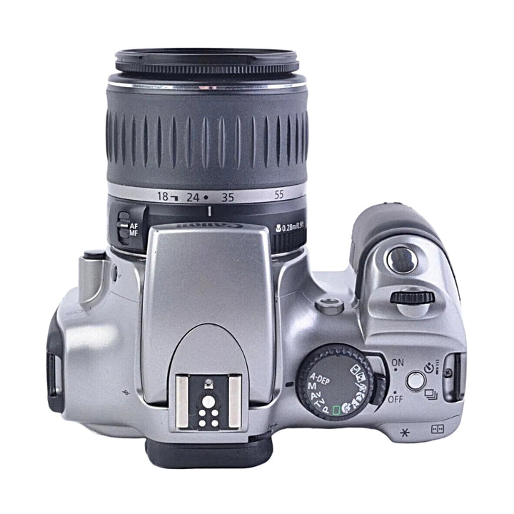 Top angled view silver Canon EOS Digital Rebel 300D DSLR showing mode dial and hot shoe at ClubCamera.com