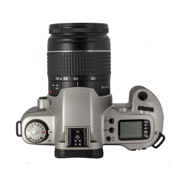 Top-down view of silver Canon EOS Rebel G showing mode dial settings P A S M B and focus scale on ClubCamera.com listing