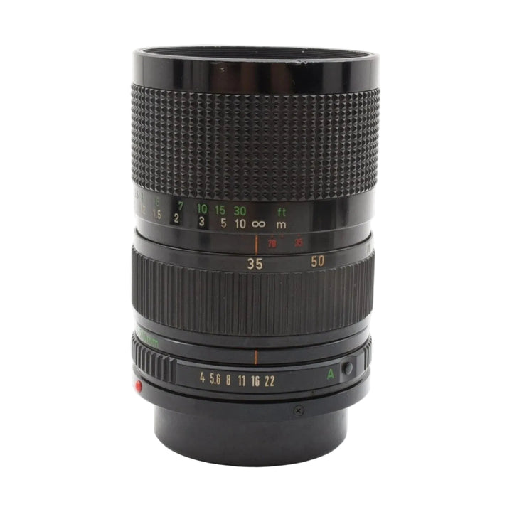 Front view of black Canon FD 35-70mm f/4 manual focus lens showing gold f-stops and distance scale from ClubCamera.com