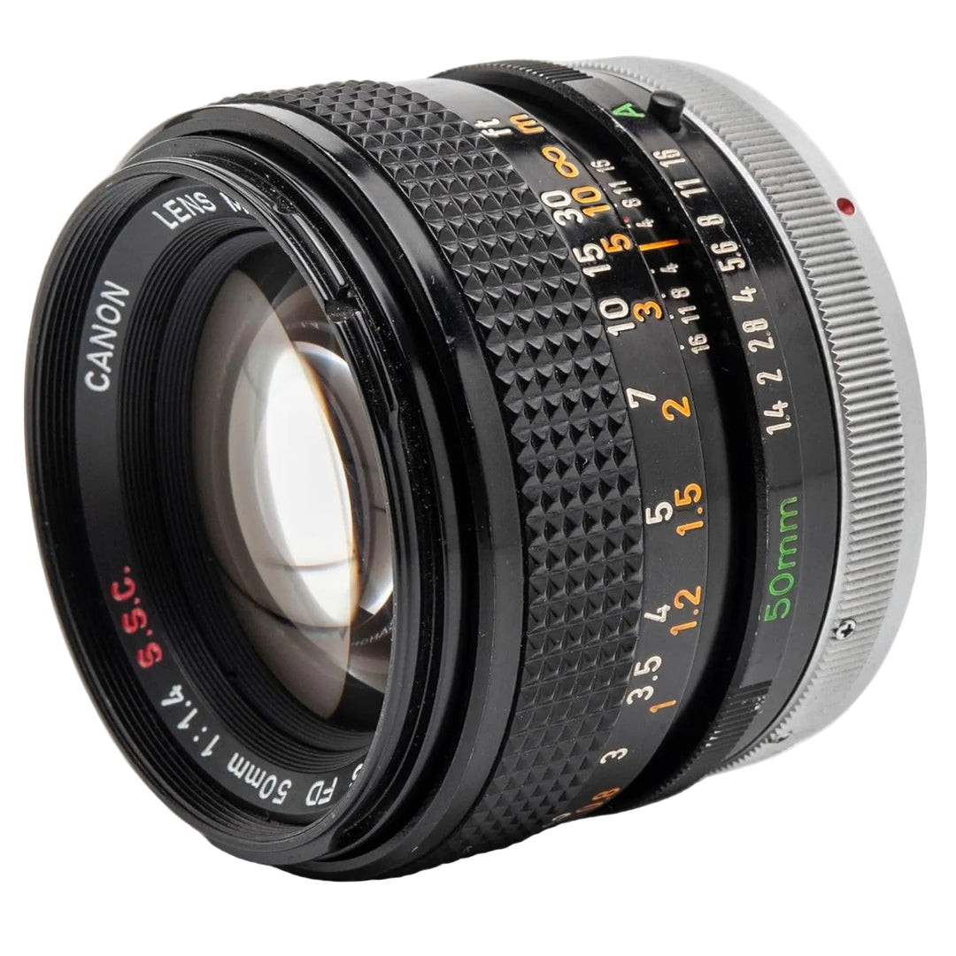 FD-mount prime lens for Canon film SLRs showing orange aperture ring and green scale from ClubCamera.com
