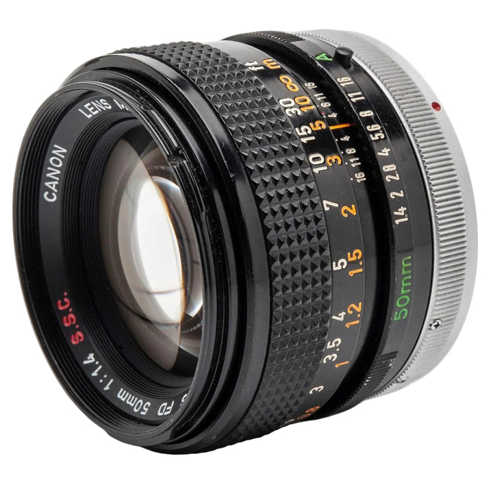 FD-mount prime lens for Canon film SLRs showing orange aperture ring and green scale from ClubCamera.com