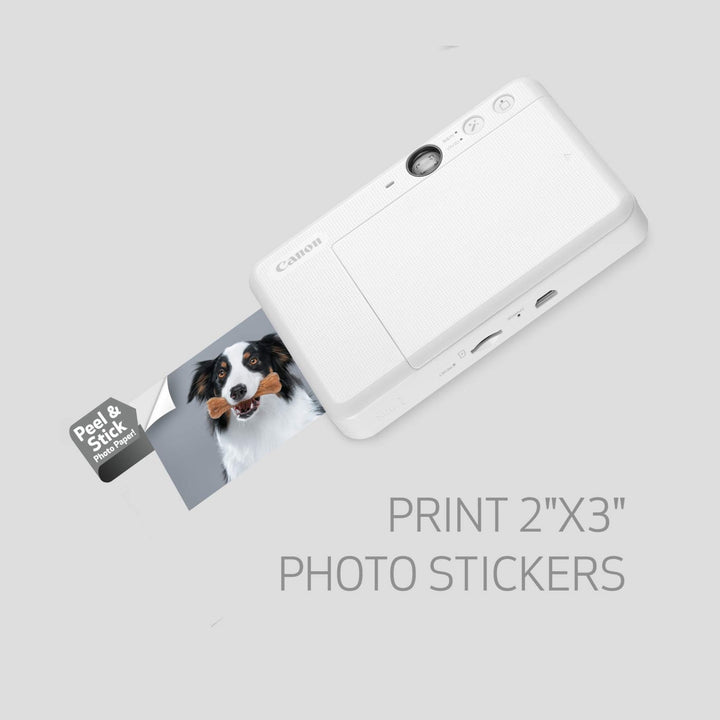 White Canon Ivy Cliq2 printer showing USB-C port and rear panel printing black and white dog sticker at ClubCamera.com