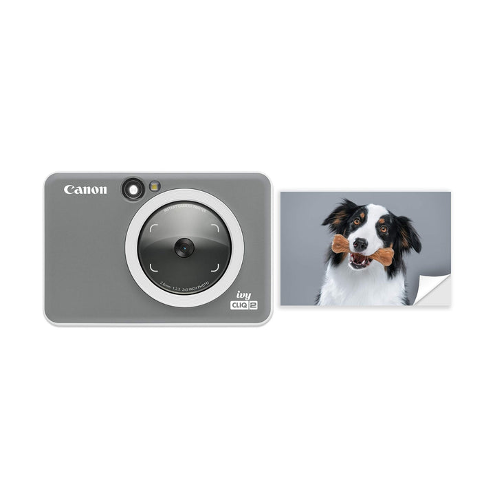 Charcoal Canon Ivy Cliq2 digital photo printer showing adhesive backing on 2x3 prints at ClubCamera.com