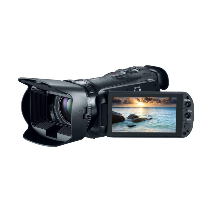 Black Canon VIXIA HF G20 camcorder side profile with extended flip-out LCD showing sunset beach scene, ClubCamera.com