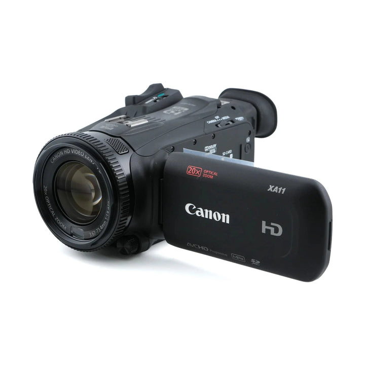 Black Canon XA11 HD camcorder side profile highlighting ribbed focus ring and AVCHD screen icons at ClubCamera.com