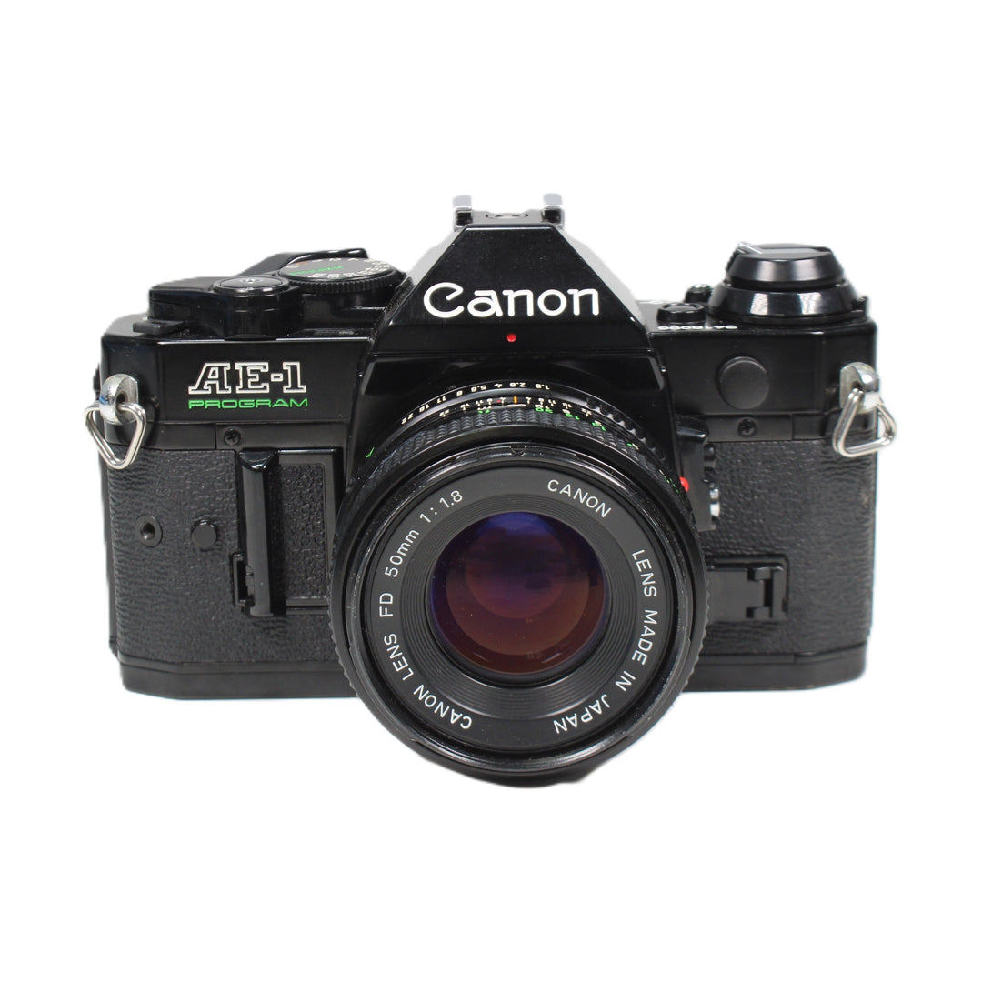 Canon AE-1 Program black film camera with 50mm FD lens at ClubCamera.com front view
