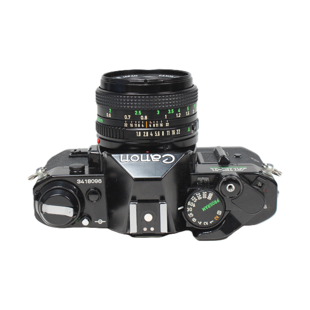 Top view of black Canon AE-1 Program mode dial and serial number at ClubCamera.com