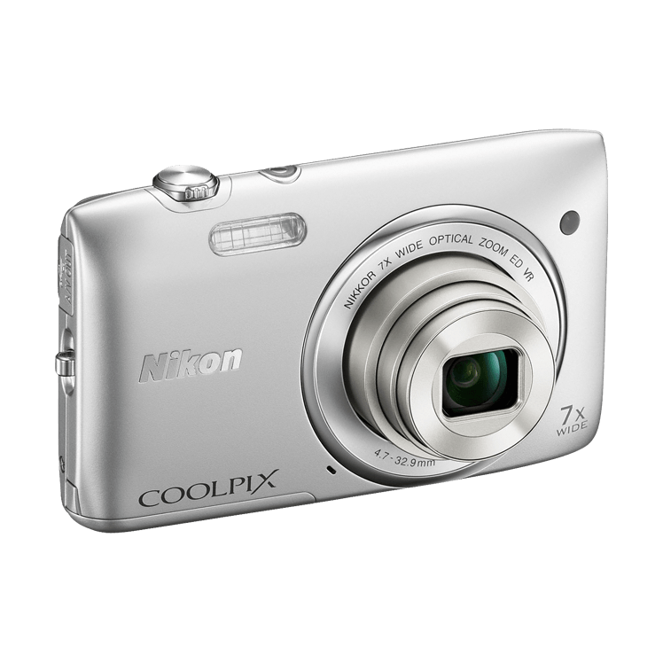 Silver Nikon Coolpix S3500 compact digital camera three-quarter view showing textured mode dial and grip at ClubCamera.com