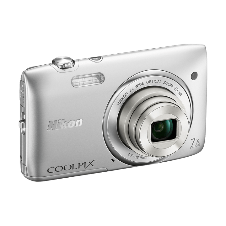 Silver Nikon Coolpix S3500 compact digital camera three-quarter view showing textured mode dial and grip at ClubCamera.com